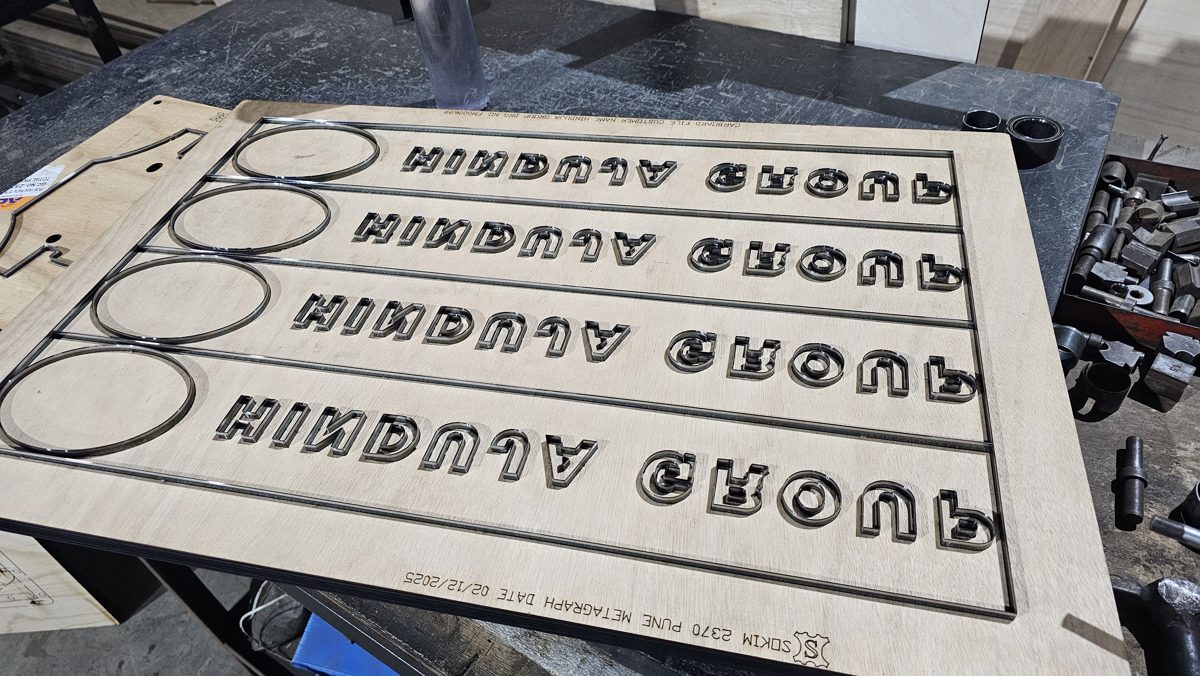 SOKIM Die Maker — multi cavity steel rule lettering die on plywood board